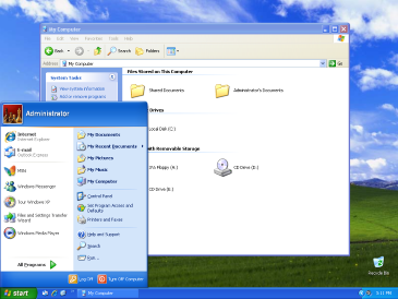 A screenshot from a Windows XP desktop, a style of computing environment popular in the 2000s. The background image is a green field and the windows are full of blue accents.